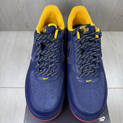 Nike blue trainers with gold accents and retro design elements.