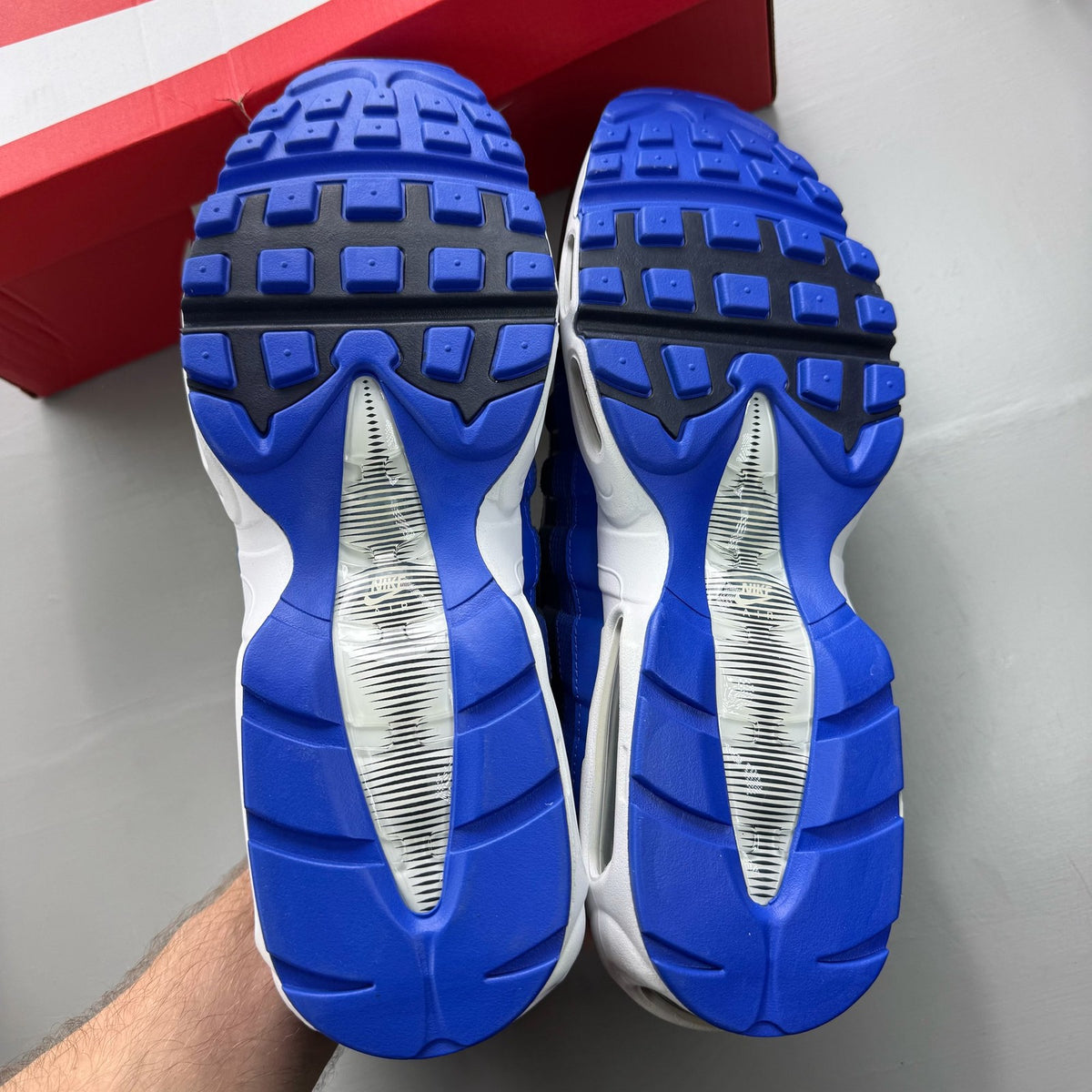 Nike Air Max 95 black trainers with royal blue accents and white detailing.