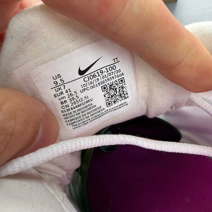 Nike white trainers with fire pink accents and Air Max logo detail.