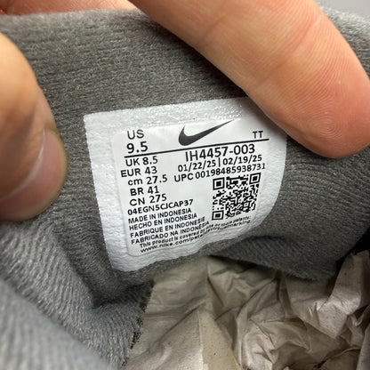 Nike Air Max 95 grey trainers with green accents and signature swoosh logo.