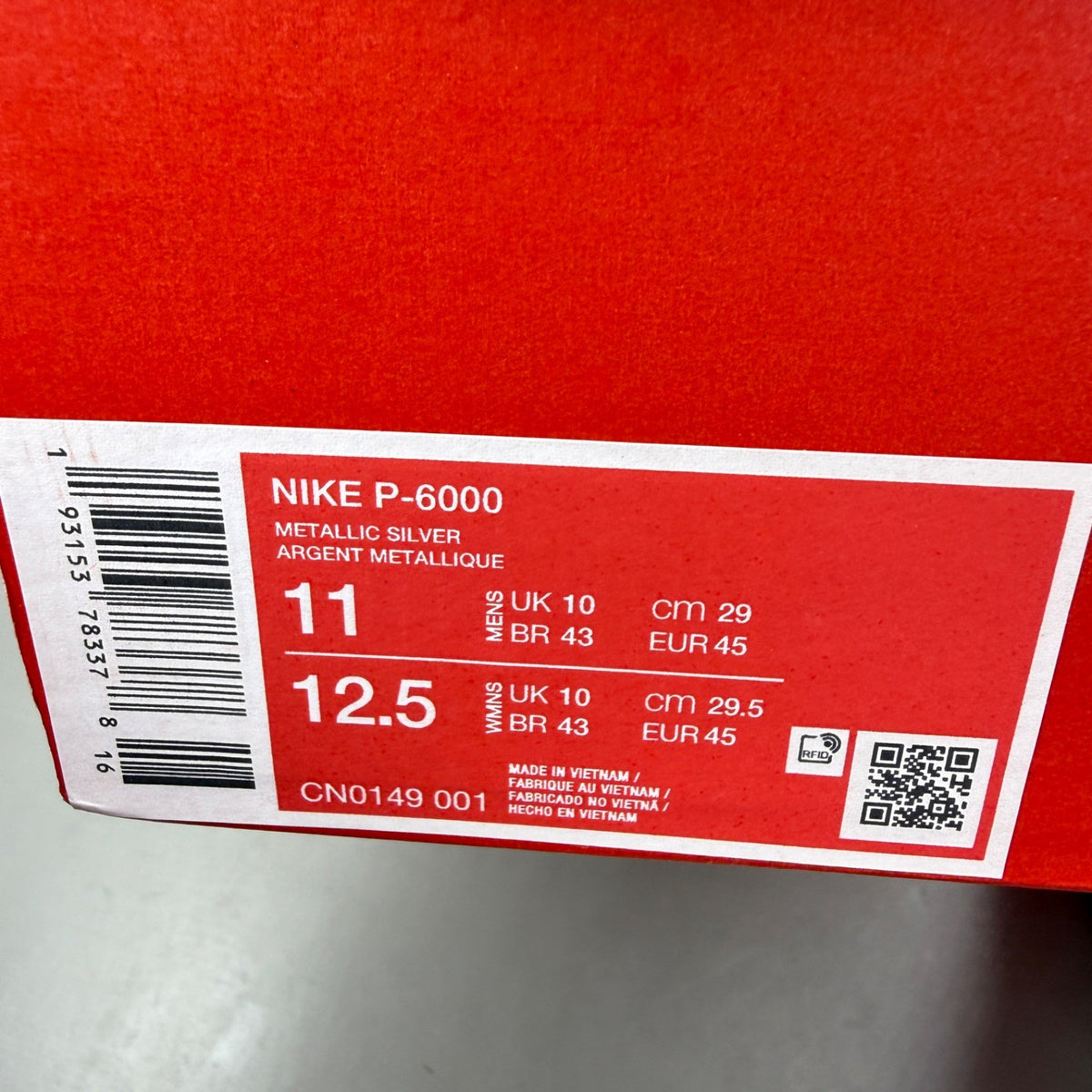 Nike deck shoes metallic silver with black and white accents, featuring logo details.