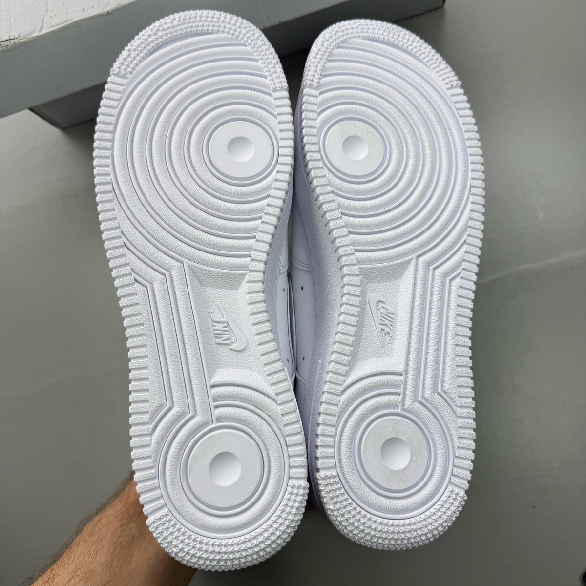 Nike Air Force 1 '07 white trainers with classic silhouette and embossed logo.