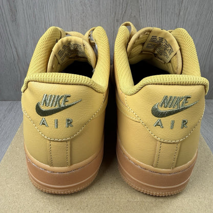 Nike Air Force 1 trainers brown suede upper with gum sole and logo detail.
