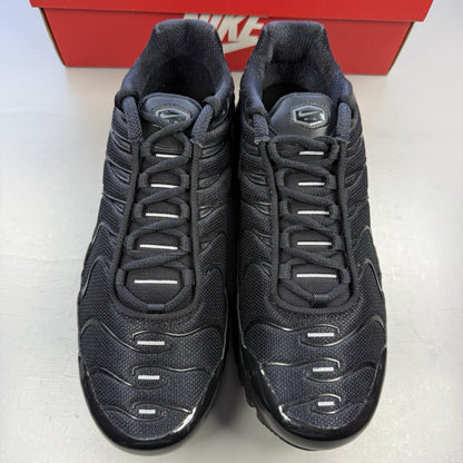 Nike Air Max Plus TN black trainers featuring distinctive wavy design and cushioned sole.
