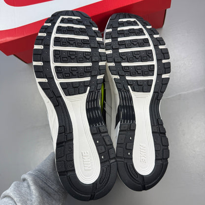 Nike athletic shoes grey with black and volt accents, mesh upper and logo detail.