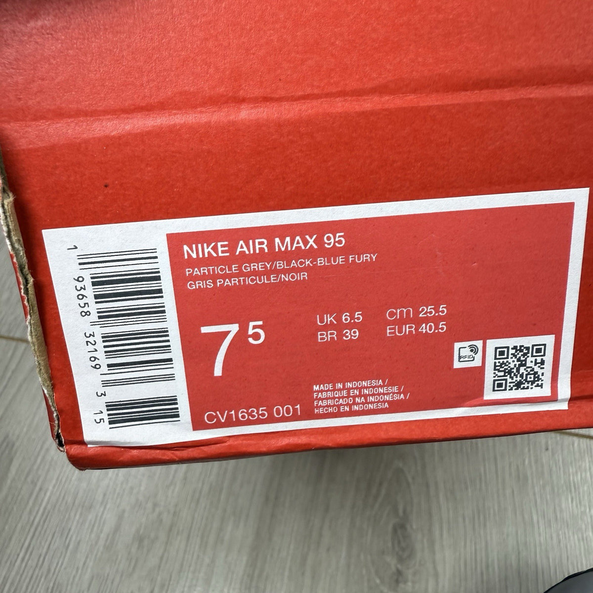 Nike Air Max 95 trainers grey with aqua blue accents and retro logo details.