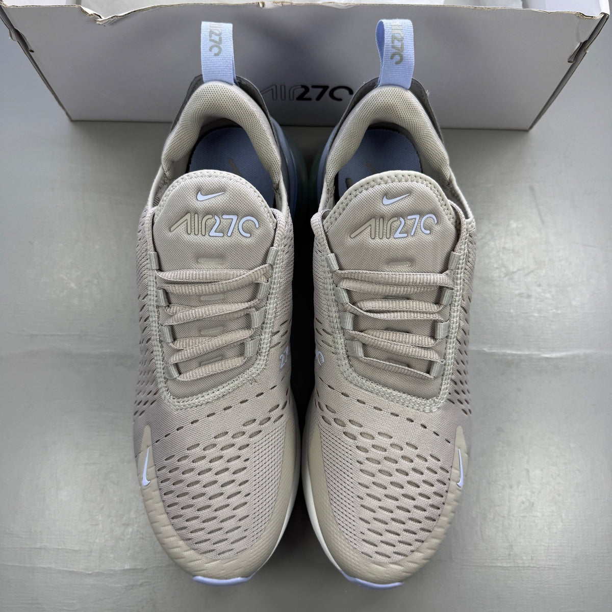 Nike grey trainers with Air Max cushioning and logo detail on the tongue.