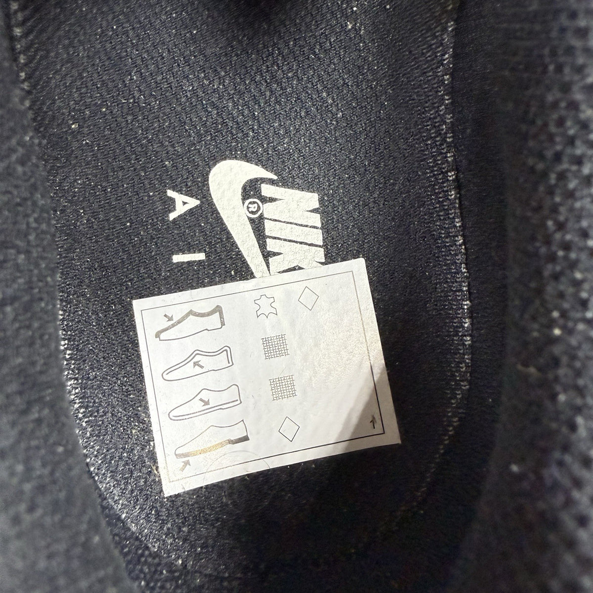 Nike Air Force 1 Low trainers black with white swoosh logo and sail accents.