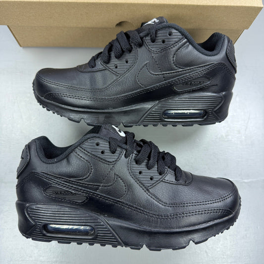 Nike black athletic shoes leather with Air Max logo and triple black design.