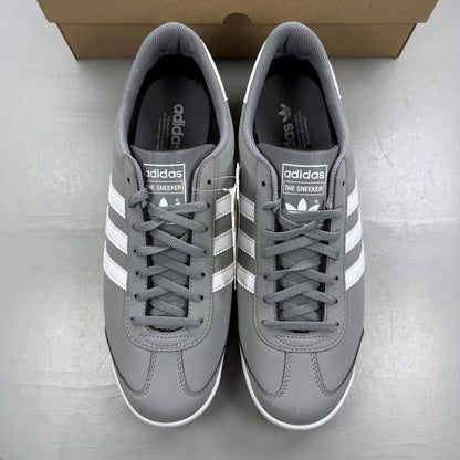 Adidas grey deck shoes with white accents and classic logo detailing.