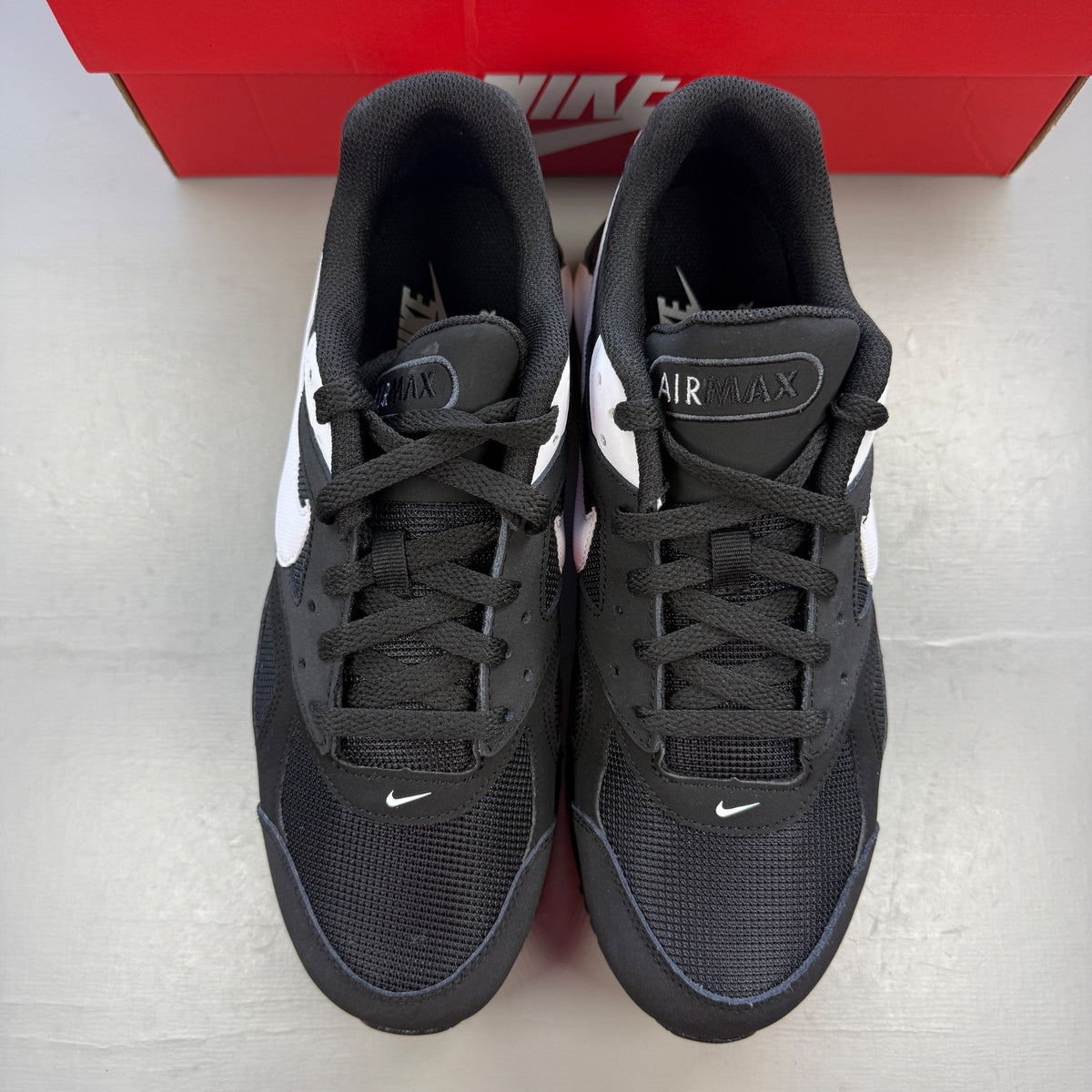 Nike running shoes black and white, featuring classic logo and sleek design.