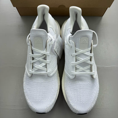 Adidas Ultra Boost 20 white running trainers with mesh upper and signature three stripes.
