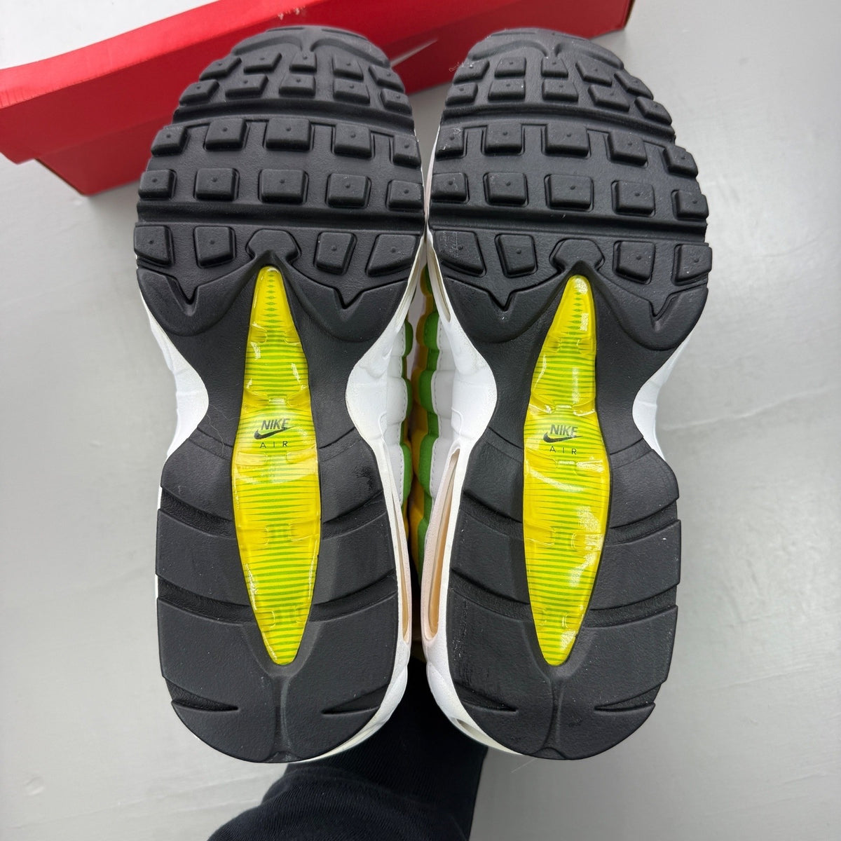 Nike trainers yellow with white accents and green apple details, featuring iconic Air Max design.