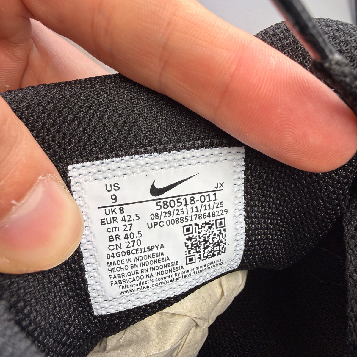 Nike running shoes black and white, featuring classic logo and sleek design.