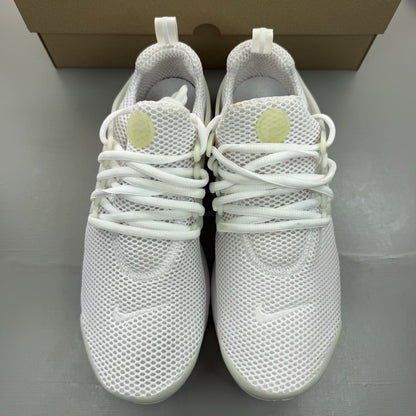Nike Air Presto white trainers with black accents and mesh upper.