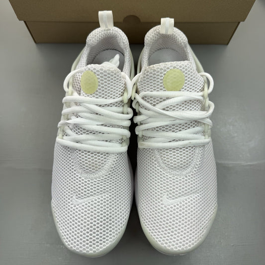 Nike Air Presto white trainers with black accents and mesh upper.
