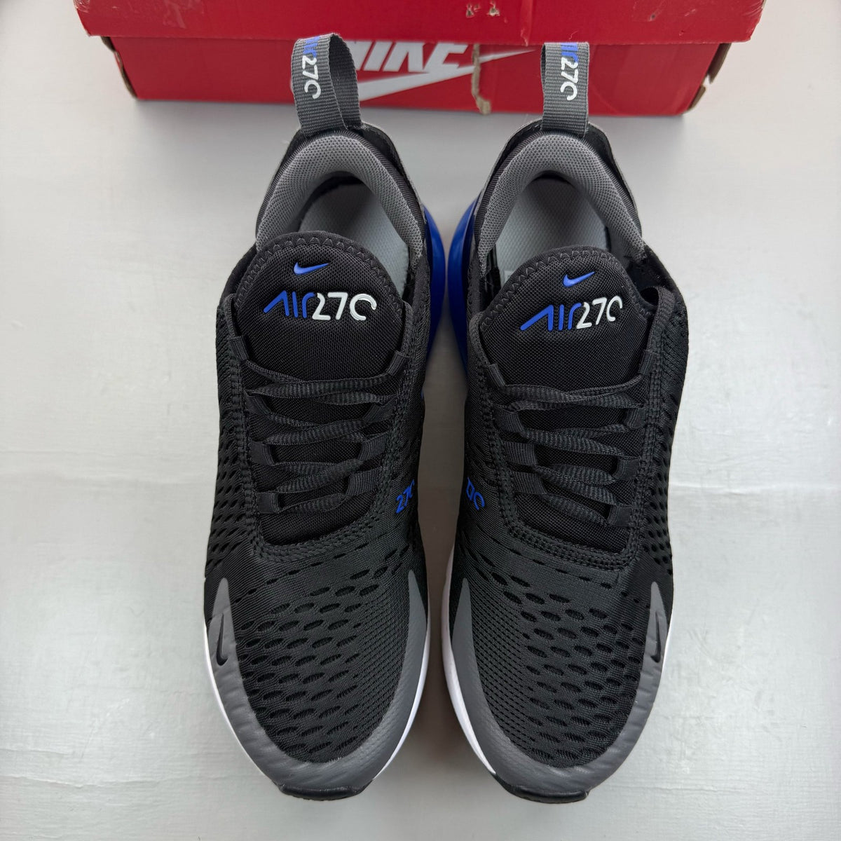 Nike Air Max 270 black trainers with game royal and white accents, mesh upper.