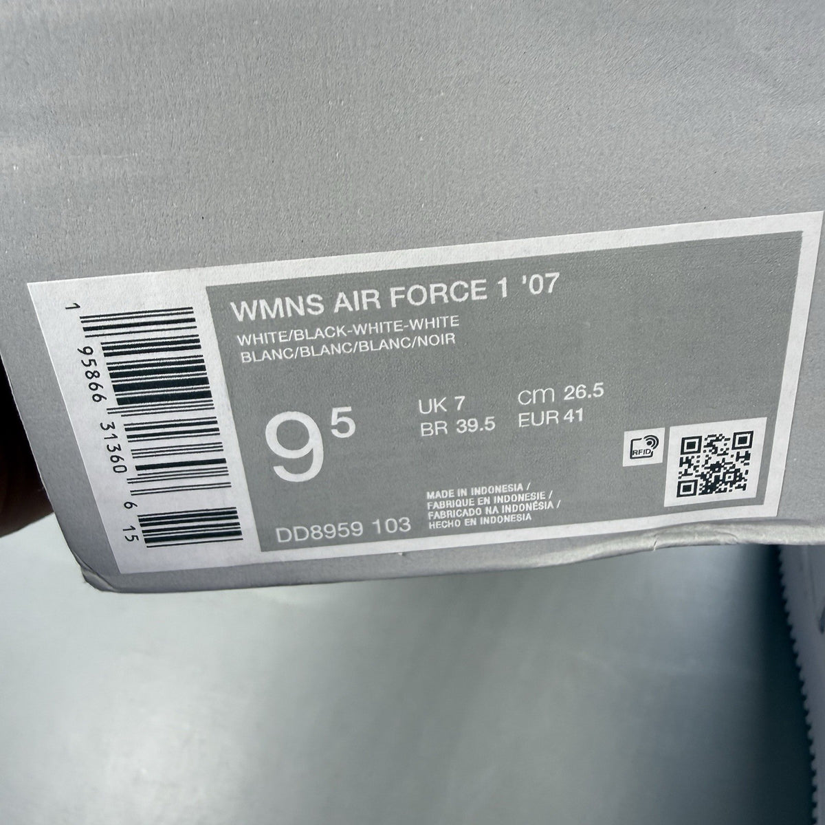 Nike Air Force 1 Low trainers white with black swoosh logo and leather upper.