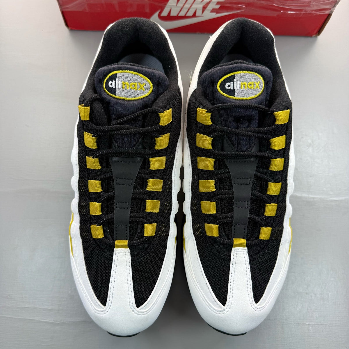 Nike Air Max 95 white trainers with big bubble sole and logo detail.