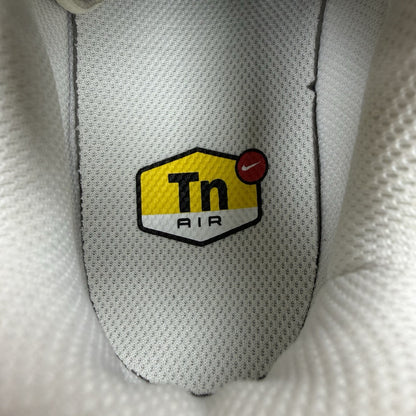 Nike Air Max Plus TN ESS trainers white with black accents and signature swoosh logo.