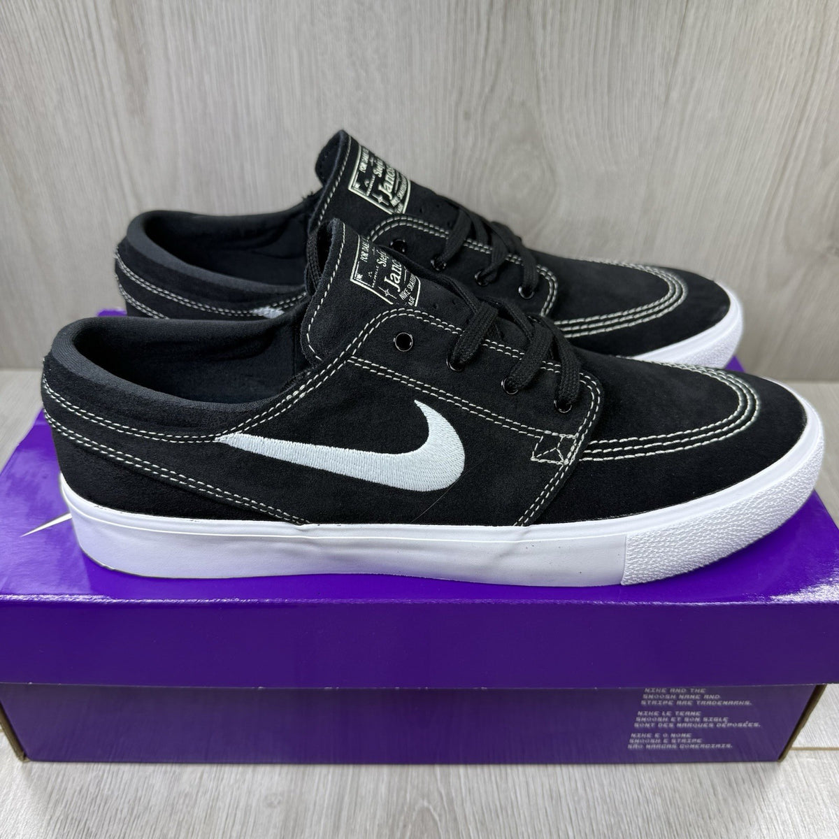 Nike black SB Zoom Stefan Janoski RM sneakers with white logo and sleek design.