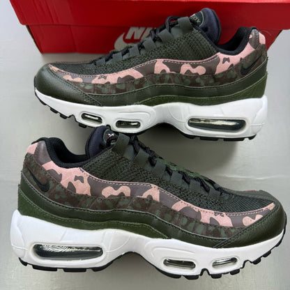 Nike black trainers with pink camo accents and white sole, featuring logo details.