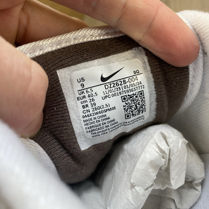 Nike Air Max 1 '87 trainers white with grey accents and brown detailing.