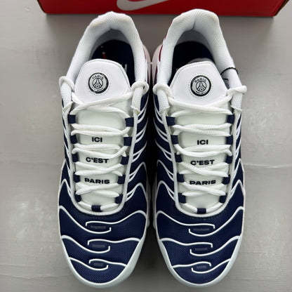 Nike Air Max Plus trainers white with navy and red accents, featuring logo details.