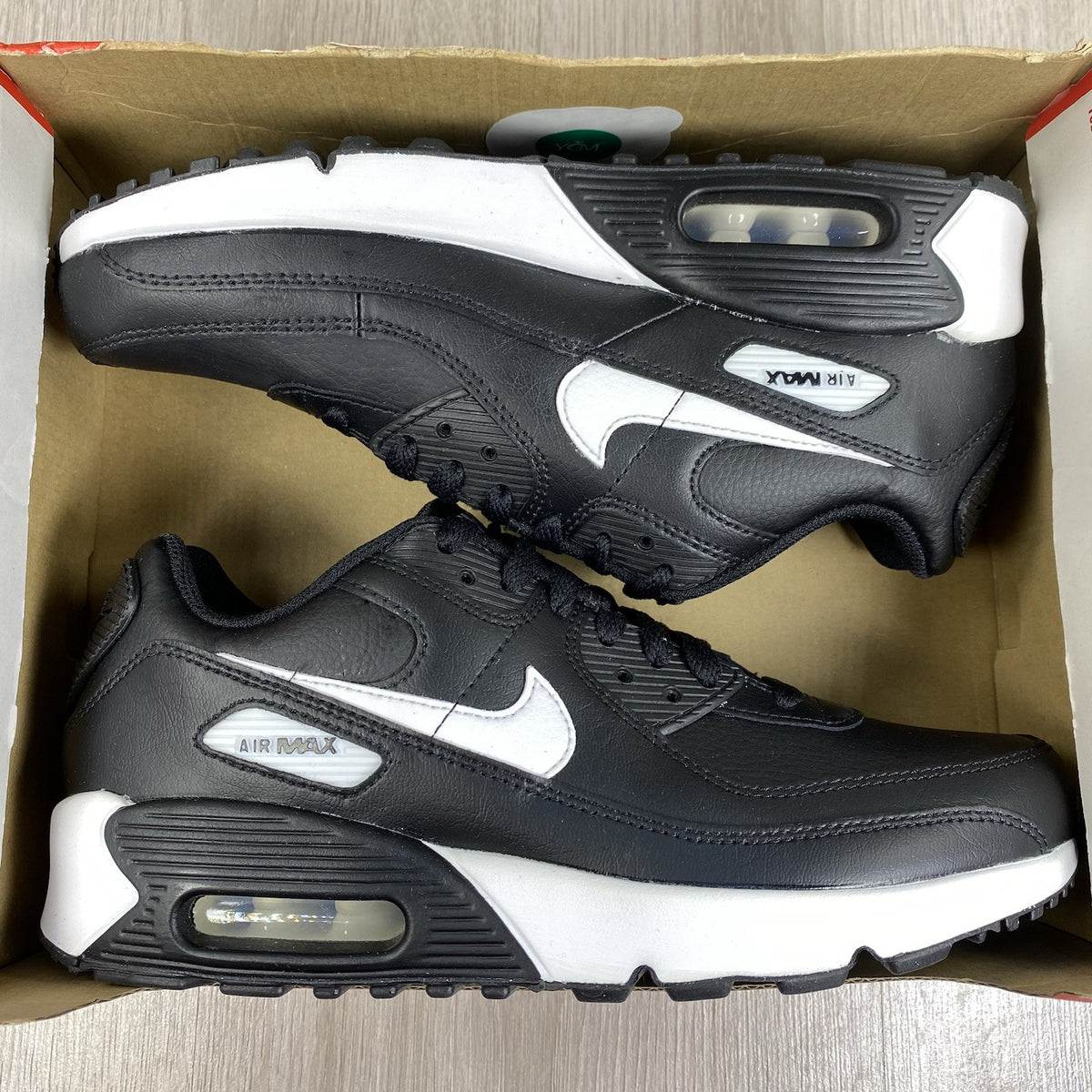 Nike Air Max 90 LTR trainers black leather with white accents and signature logo.