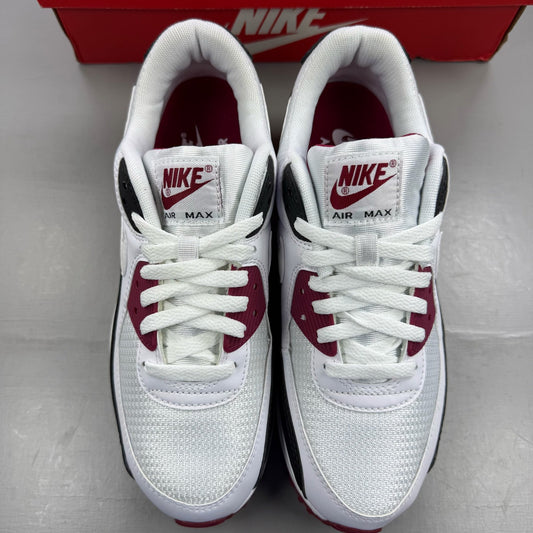Nike Air Max 90 Recraft white trainers with maroon accents and logo detail.
