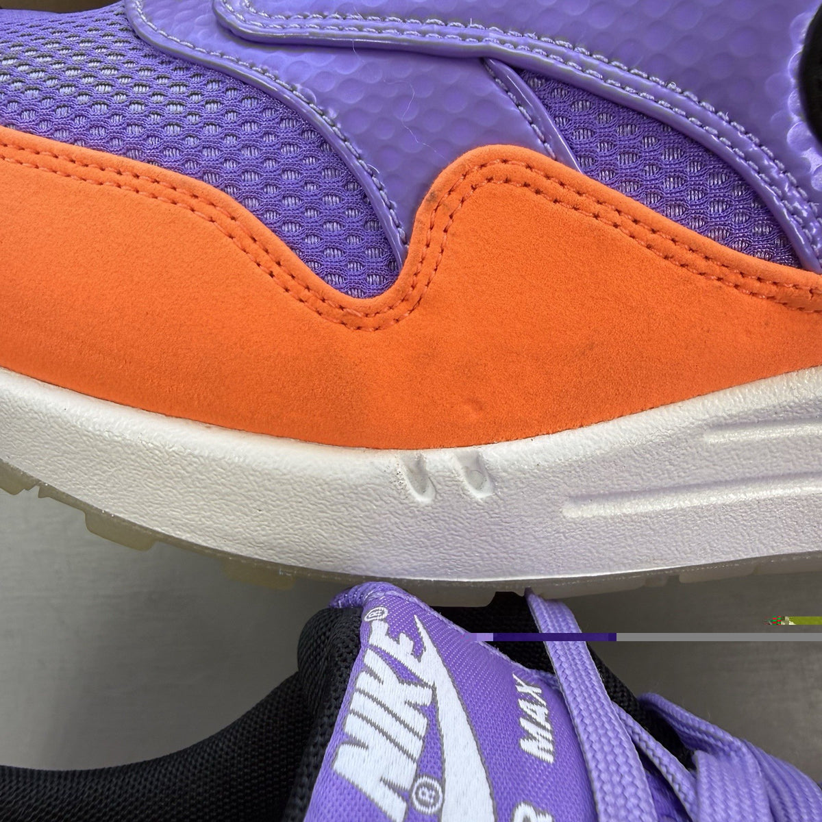 Nike Air Max 1 white trainers with atomic violet and orange accents, 100% authentic.