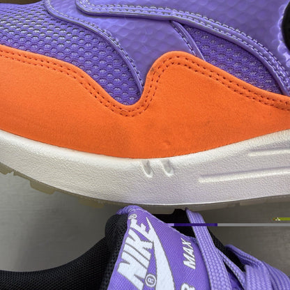 Nike Air Max 1 white trainers with atomic violet and orange accents, 100% authentic.