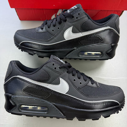Nike Air Max 90 Premium black trainers with silver reflective accents and logo details.