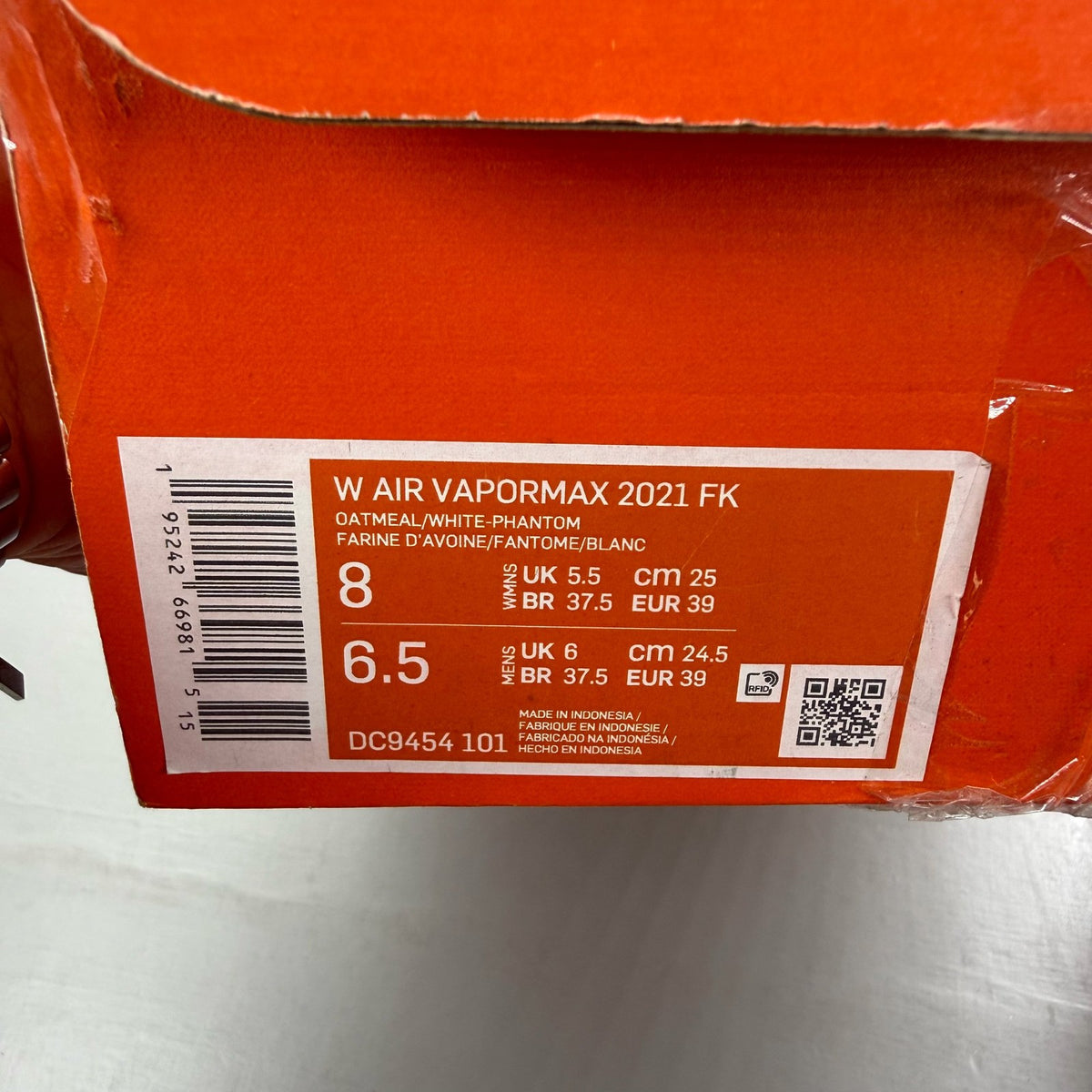 Nike Air VaporMax 2021 FK white trainers with breathable knit upper and signature swoosh logo.