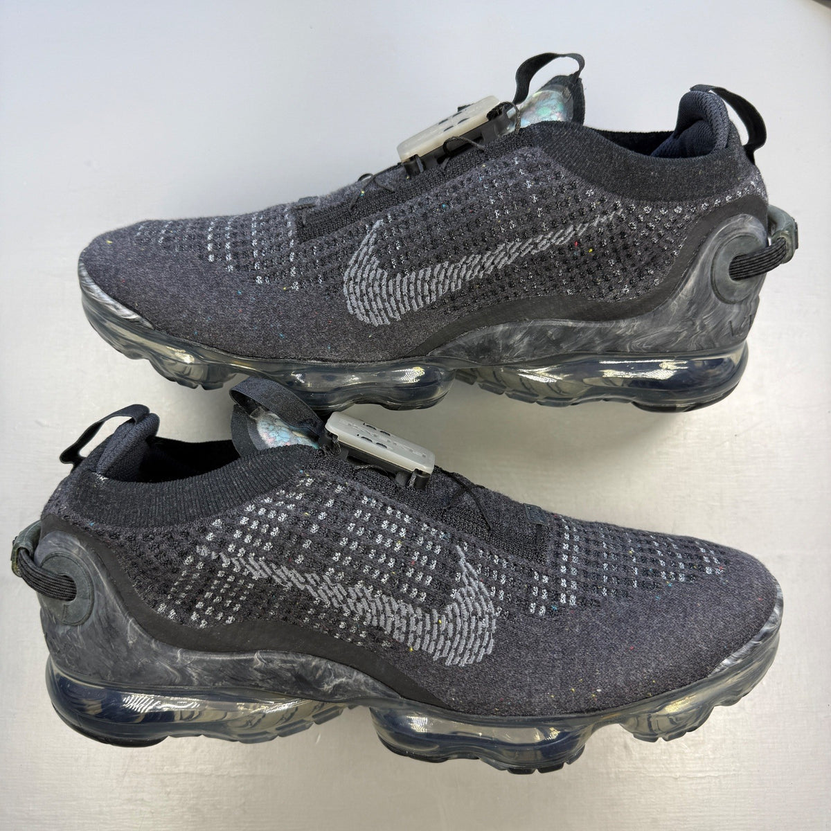 Nike black trainers Flyknit upper with grey accents and Air Max cushioning.