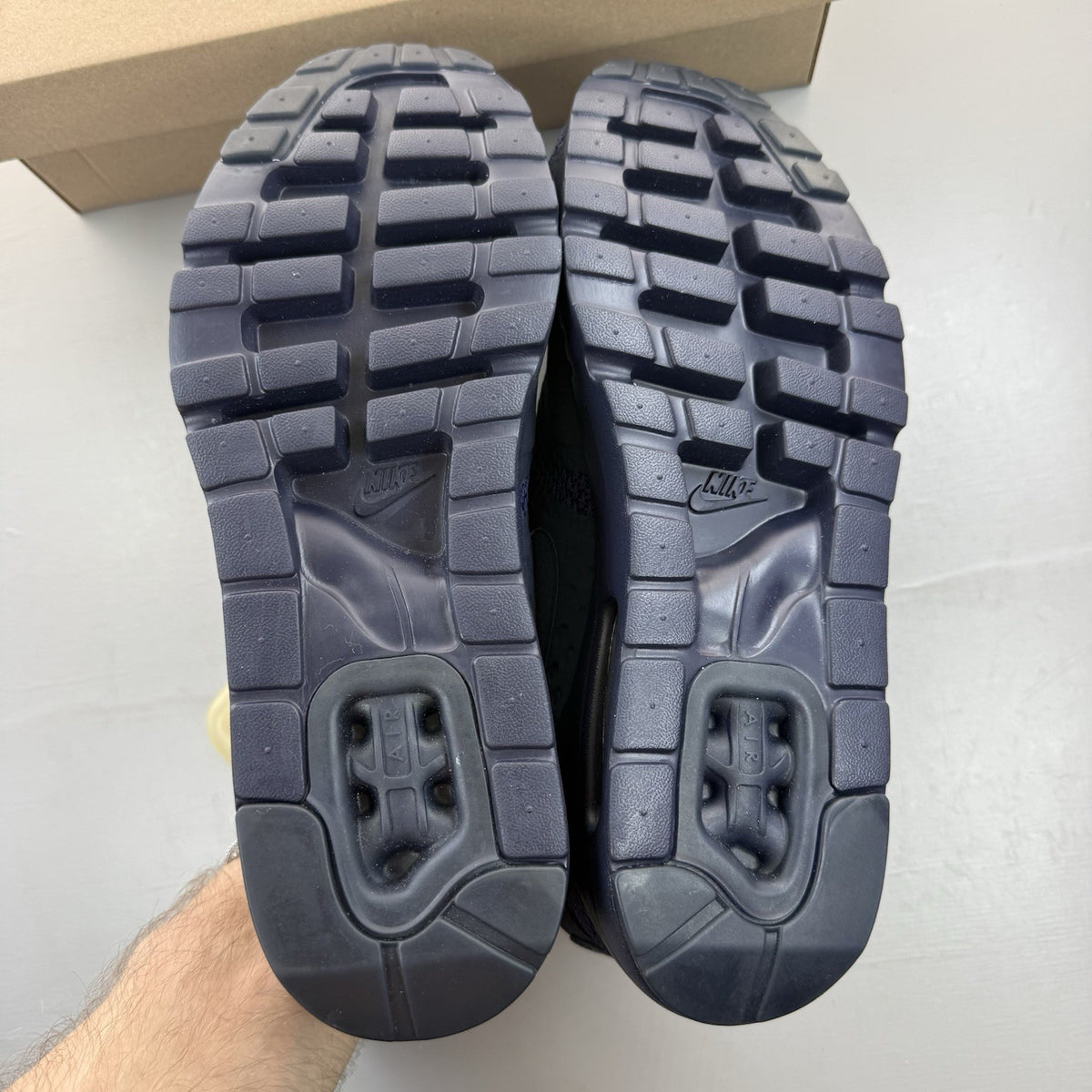Nike Air Max Zero blue trainers with black accents and logo detailing.