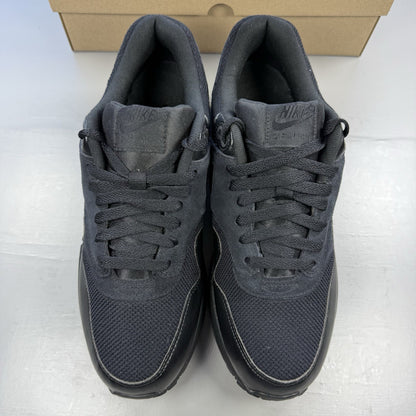 Nike black Air Max 1 Essential trainers with signature swoosh logo and mesh detailing.