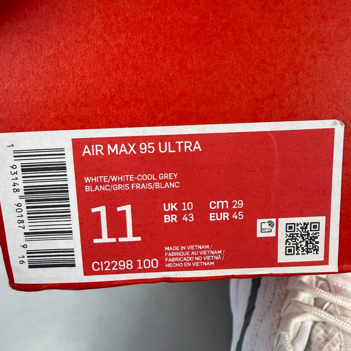 Nike Air Max 95 white trainers with grey accents and signature swoosh logo.