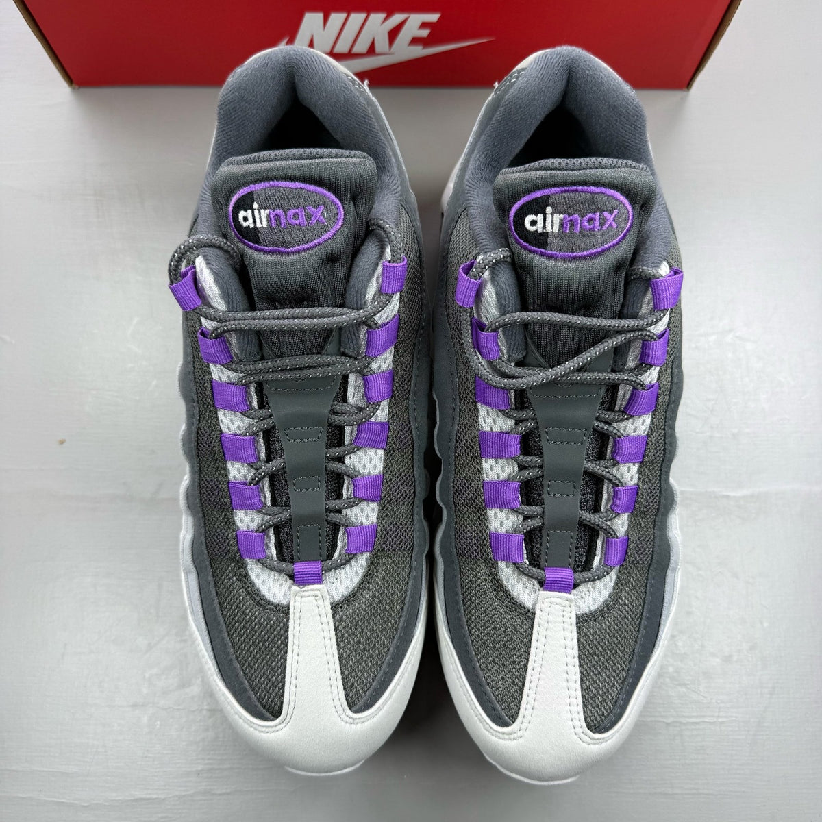 Nike Air Max 95 grey trainers with big bubble sole and logo detailing.