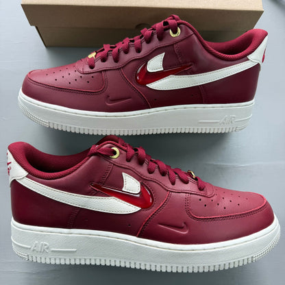 Nike Air Force 1 red trainers with premium materials and classic silhouette.