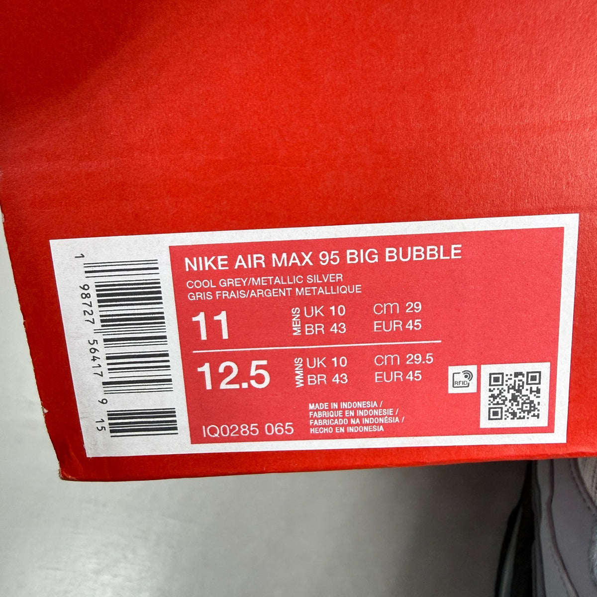 Nike running shoes grey with big bubble sole and reflective detailing.
