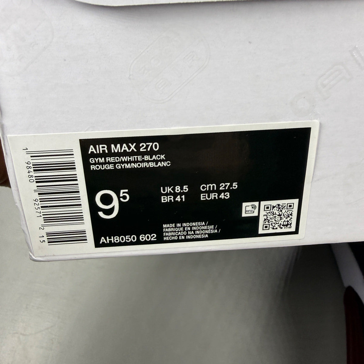 Nike trainers red with black and white accents, featuring Air Max cushioning and logo.