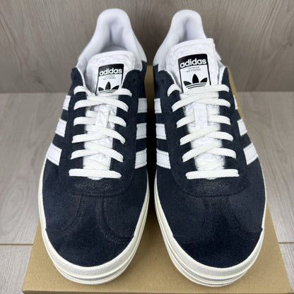 Adidas Gazelle Bold black trainers with white stripes and logo detailing.
