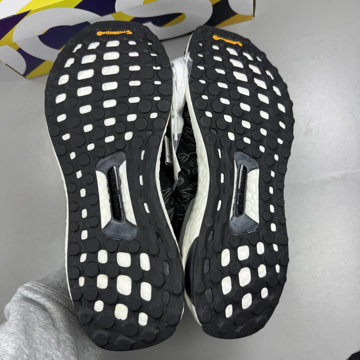 Adidas Ultra Boost black trainers with Undefeated logo and breathable mesh upper.