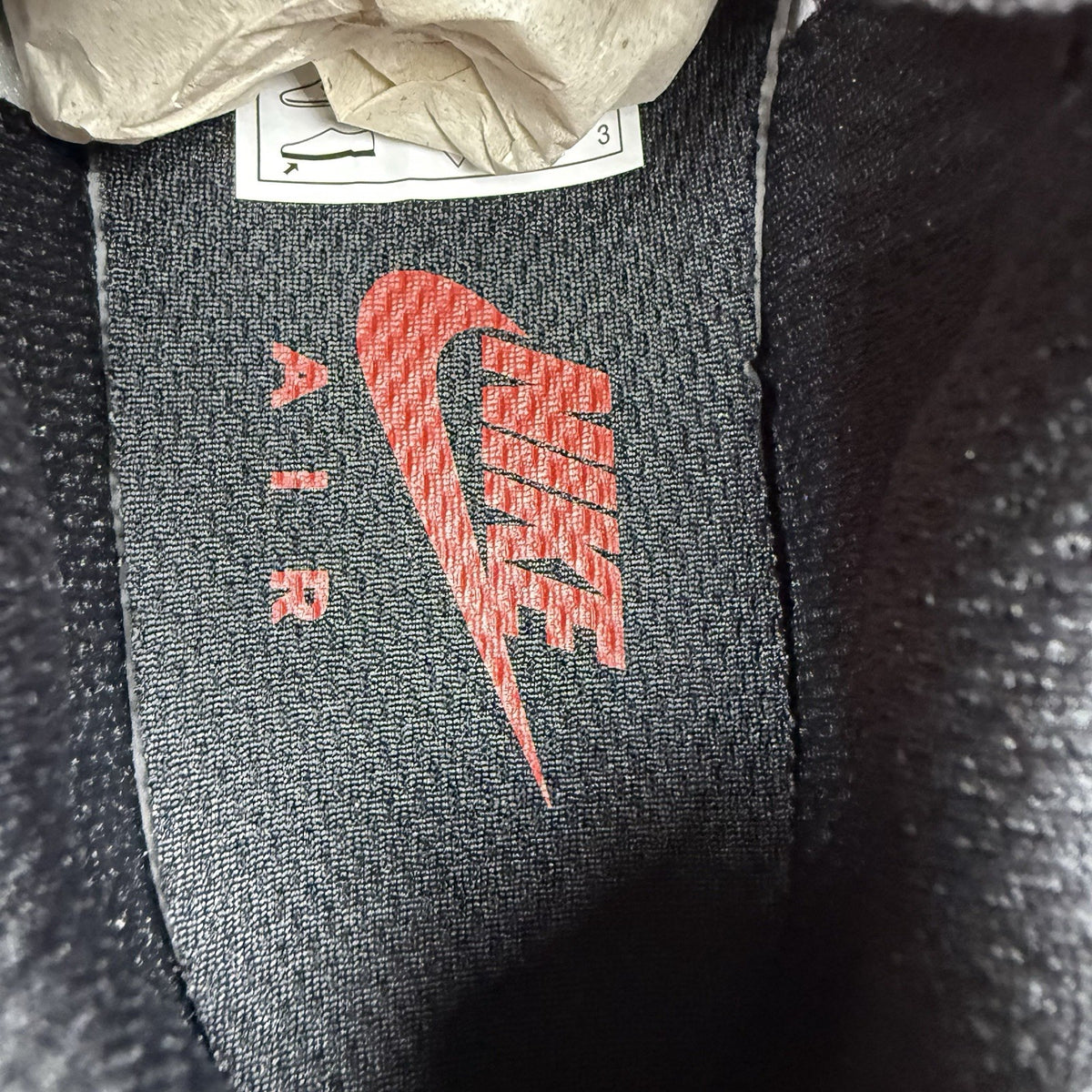 Nike TN Air Max Plus trainers black with red gradient and signature logo design.