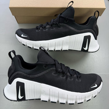 Nike black trainers with white accents and breathable mesh upper.