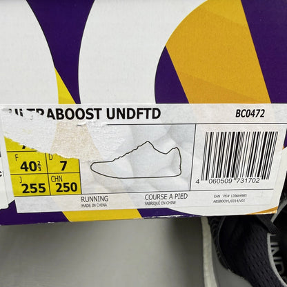 Adidas Ultra Boost black trainers with Undefeated logo and breathable mesh upper.