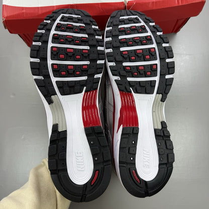Nike P-6000 trainers in metallic silver with red and black accents, mesh upper.