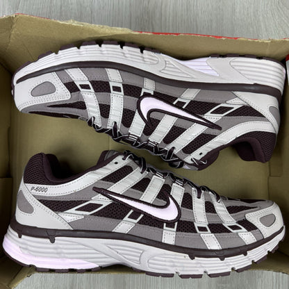 Nike P-6000 trainers purple with pink accents and mesh material detailing.