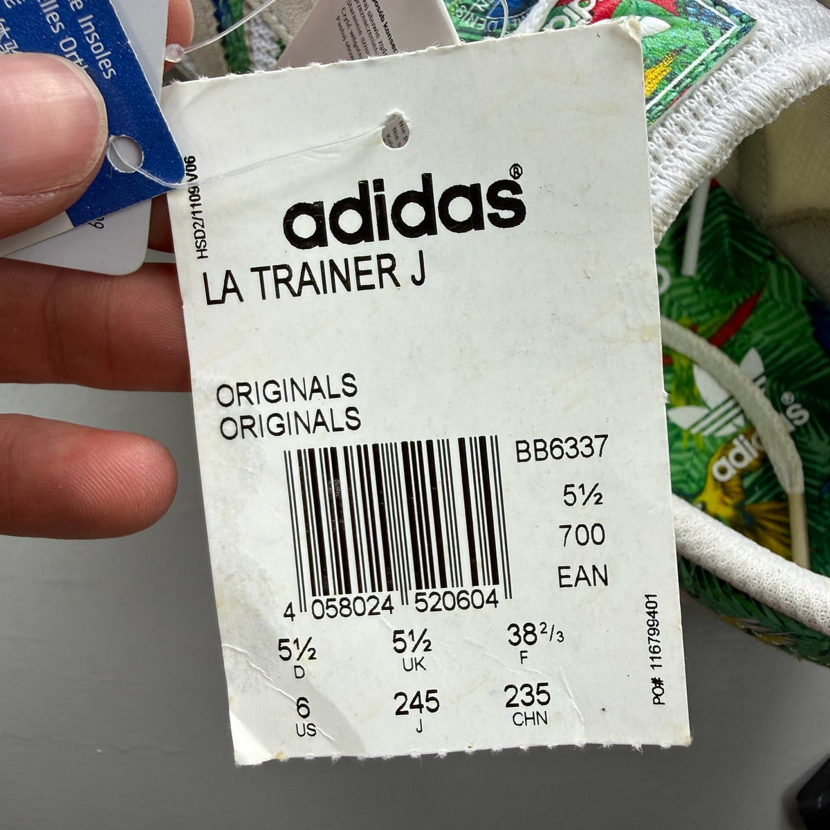 Adidas white LA Trainer with tropical pattern and logo detail on the side.